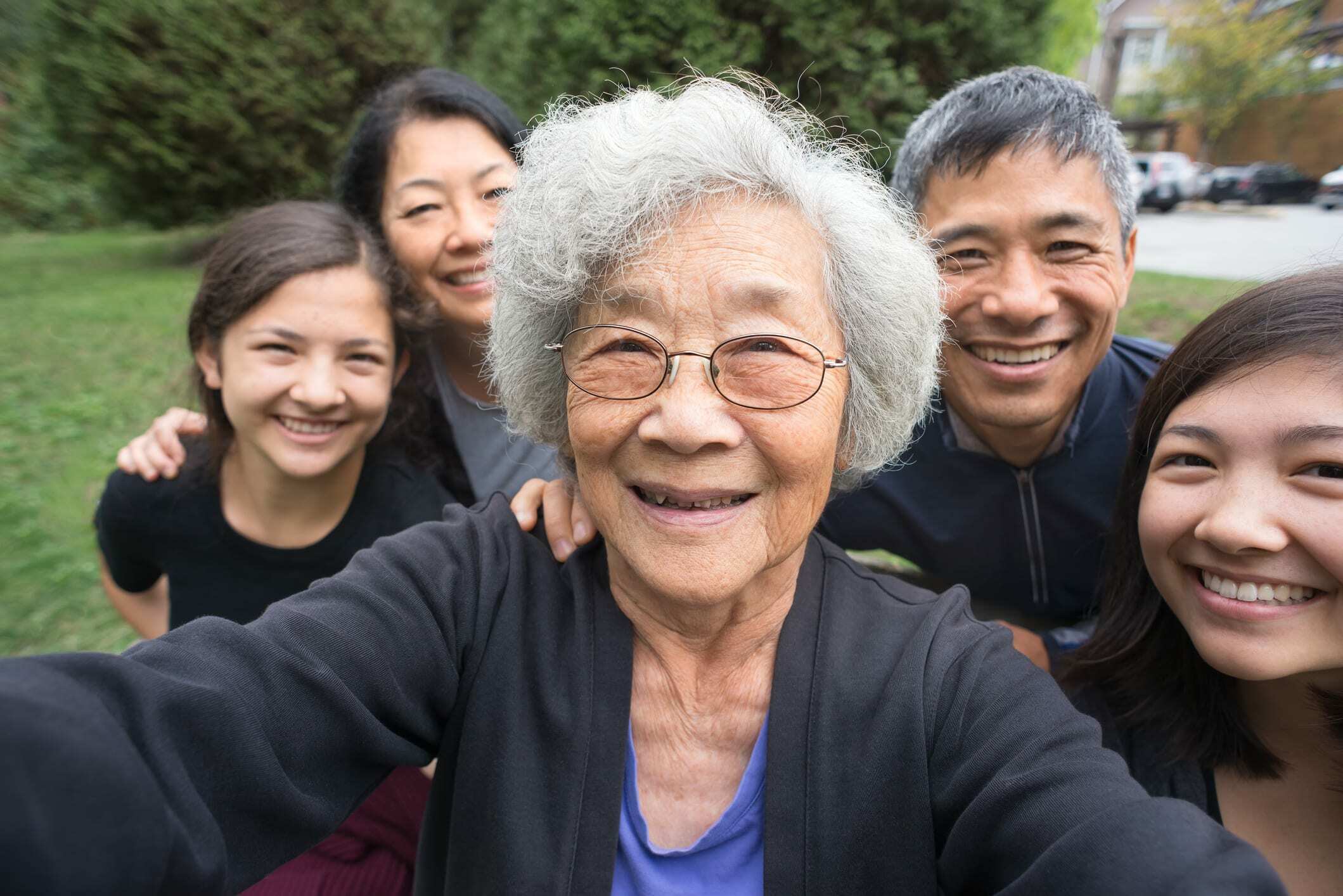 Grandmother, Children, Grandchildren Pose For Selfie, Care Home In Background