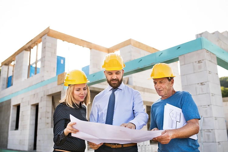 Architects And Worker At The Construction Site.